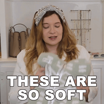 A Woman Wearing A Headband And A White Jacket Says These Are So Soft GIF