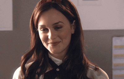 A Woman Wearing A Headband And A White Shirt Smiles GIF