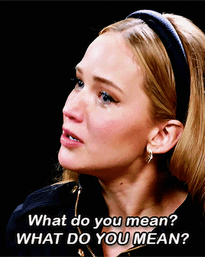 A Woman Wearing A Headband And Earrings Says What Do You Mean GIF