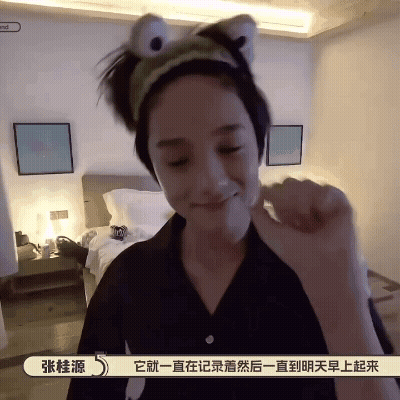 A Woman Wearing A Headband That Looks Like A Frog Is Making A Funny Face GIF