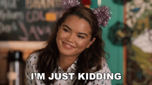 A Woman Wearing A Headband That Says ' I 'M Just Kidding ' GIF