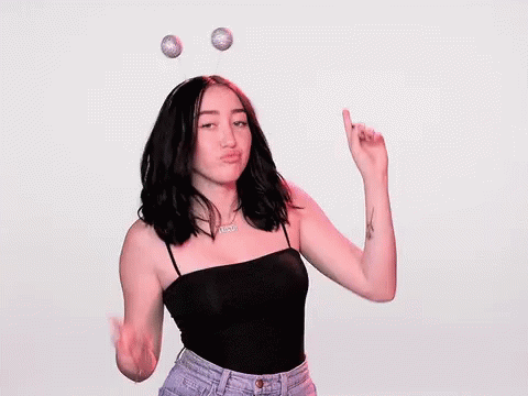 A Woman Wearing A Headband With Antennas On It Is Making A Middle Finger Sign . GIF