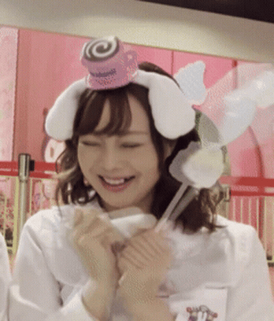 A Woman Wearing A Headband With Bunny Ears And A Lollipop On Top GIF