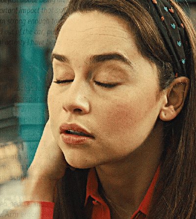 A Woman Wearing A Headband With Flowers On It GIF