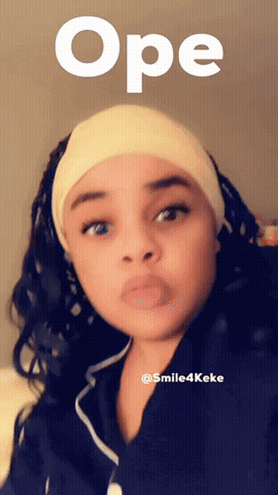 A Woman Wearing A Headband With The Word Ope Written Above Her GIF