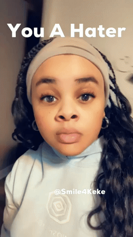 A Woman Wearing A Headband With The Words You A Hater Above Her GIF