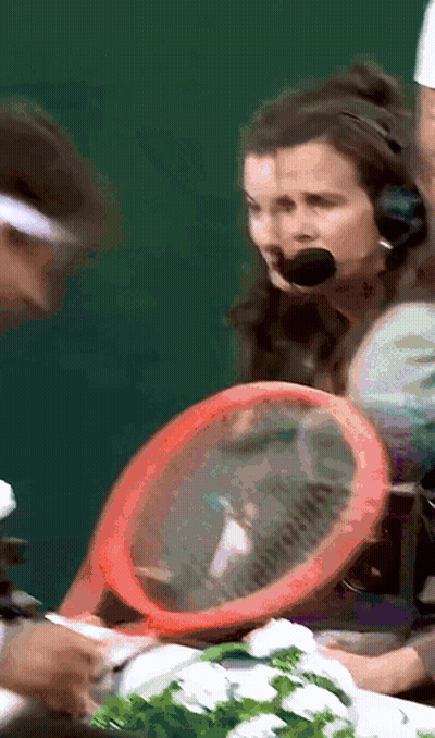A Woman Wearing A Headset Holds A Red Racket GIF