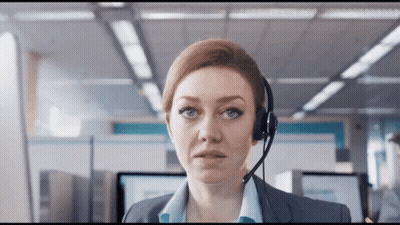 A Woman Wearing A Headset Looks At The Camera With A Serious Look On Her Face GIF