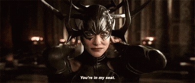 A Woman Wearing A Helmet And A Mask Is Talking To Someone . GIF