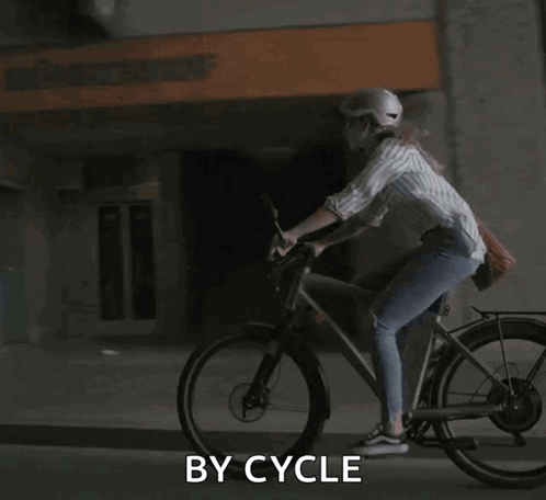 A Woman Wearing A Helmet Is Riding A Bike With The Words By Cycle Written Below Her GIF