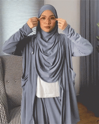 A Woman Wearing A Hijab Adjusts Her Glasses GIF