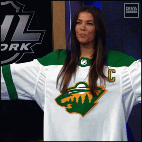 A Woman Wearing A Hockey Jersey With The Letter C On The Front GIF