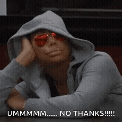 A Woman Wearing A Hoodie And Sunglasses Is Sitting At A Table With Her Head On Her Hand . GIF