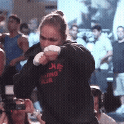 A Woman Wearing A Hoodie That Says Boxing Club On It GIF