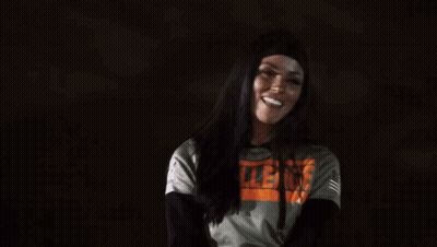 A Woman Wearing A Hoodie With The Word Violence On It . GIF