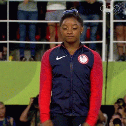 A Woman Wearing A Jacket That Says ' Usa ' On It GIF