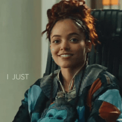 A Woman Wearing A Jacket With A Gorilla On It Smiles With The Words I Just Below Her GIF
