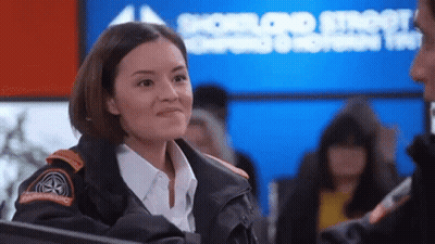 A Woman Wearing A Jacket With A Patch That Says Emergency Services On It GIF