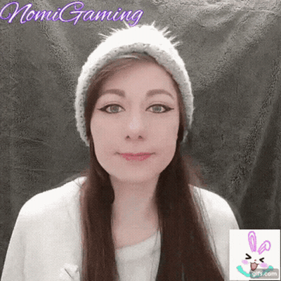 A Woman Wearing A Knitted Hat With The Name Nomi Gaming Written On The Bottom GIF