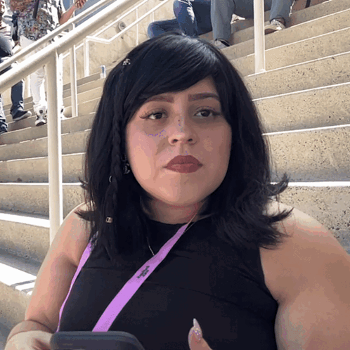 A Woman Wearing A Lanyard That Says ' Abercrombie ' On It GIF