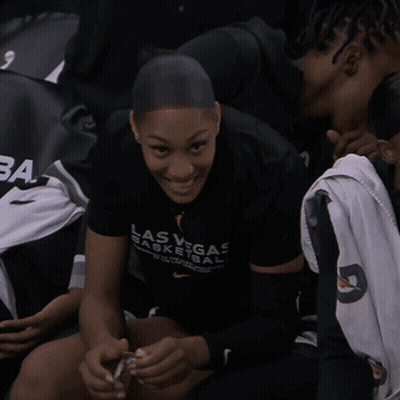 A Woman Wearing A Las Vegas Basketball Shirt Smiles GIF