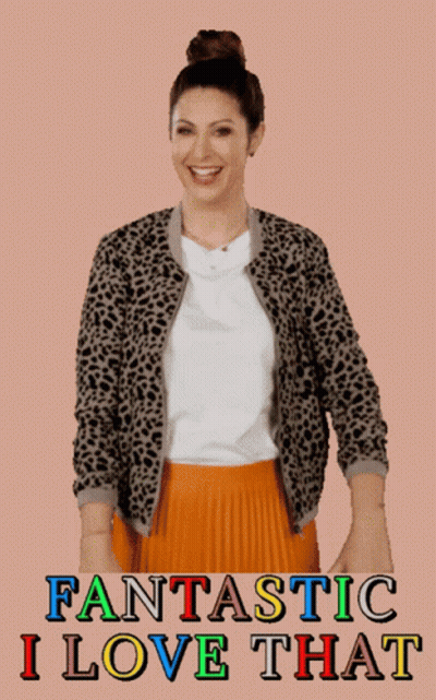 A Woman Wearing A Leopard Print Jacket And An Orange Pleated Skirt GIF
