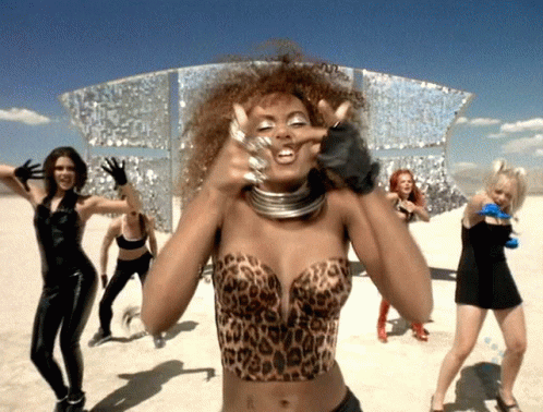 A Woman Wearing A Leopard Print Top Is Making A Funny Face GIF