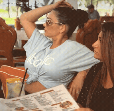 A Woman Wearing A Light Blue T-Shirt That Says Italic GIF
