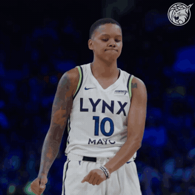 A Woman Wearing A Lynx 10 Jersey Is Dancing GIF