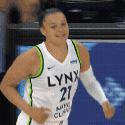 A Woman Wearing A Lynx Jersey Is Running GIF