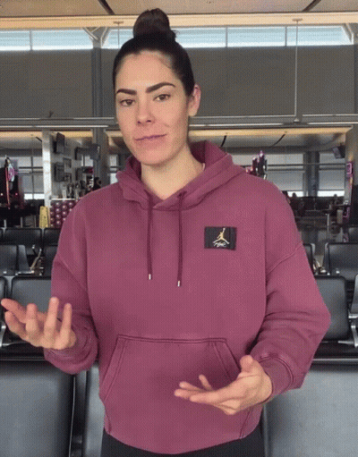 A Woman Wearing A Maroon Air Jordan Hoodie Is Talking GIF