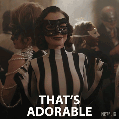 A Woman Wearing A Mask And A Striped Outfit Says That 'S Adorable On The Bottom GIF