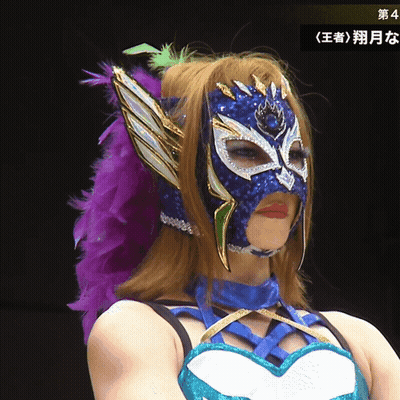 A Woman Wearing A Mask With A Purple Feather In Her Hair GIF