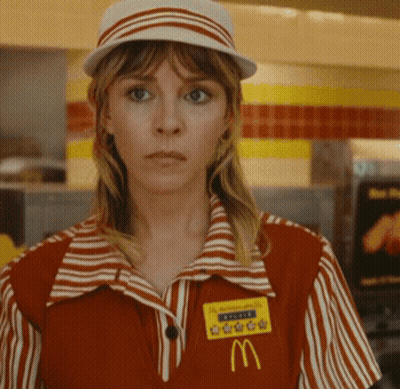 A Woman Wearing A Mcdonald 'S Uniform Has A Name Tag With The Letter M GIF