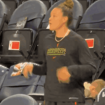 A Woman Wearing A Minnesota Basketball Shirt GIF