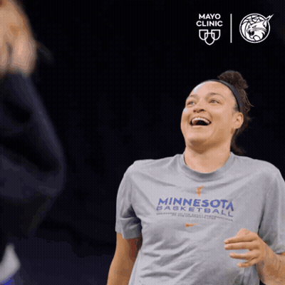 A Woman Wearing A Minnesota Basketball T-Shirt Is Laughing GIF