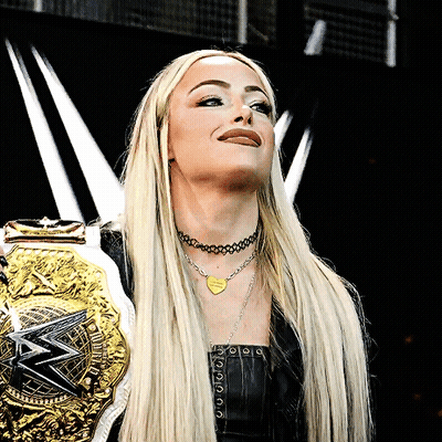 A Woman Wearing A Necklace That Says I Love You Is Holding A Wrestling Belt GIF