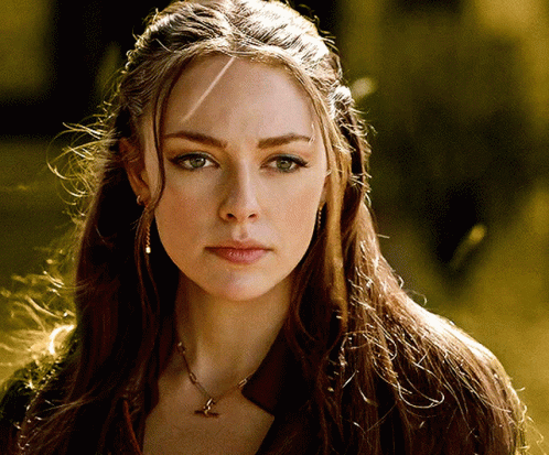 A Woman Wearing A Necklace With A Bird On It GIF
