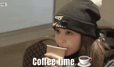 A Woman Wearing A Nike Beanie Is Drinking Coffee GIF