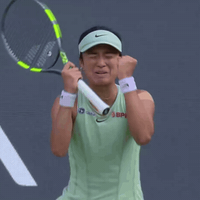 A Woman Wearing A Nike Visor Is Holding A Tennis Racquet In Her Hands GIF