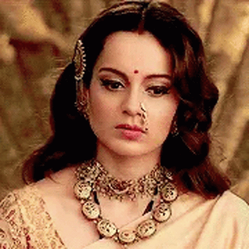 A Woman Wearing A Nose Ring And A Necklace . GIF