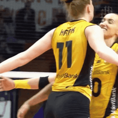 A Woman Wearing A Number 11 Jersey Is Hugging Another Woman Wearing A Number 0 Jersey GIF
