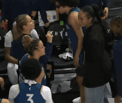 A Woman Wearing A Number 3 Jersey Talks To Another Woman GIF