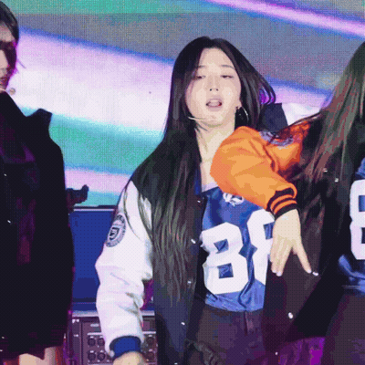 A Woman Wearing A Number 81 Jersey Is Dancing GIF