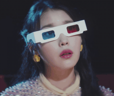 A Woman Wearing A Pair Of 3D Glasses Covering Her Face GIF