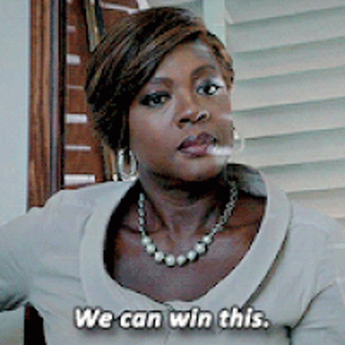 A Woman Wearing A Pearl Necklace And Earrings Says We Can Win This GIF