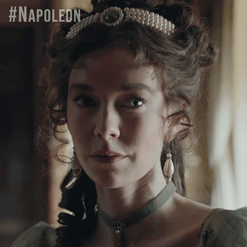 A Woman Wearing A Pearl Tiara And Earrings With The #Napoleon Hashtag GIF