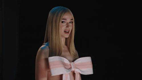 A Woman Wearing A Pink And White Striped Bow Around Her Neck GIF