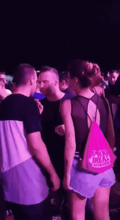 A Woman Wearing A Pink Bag That Says Shri Freak GIF