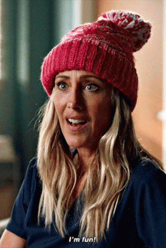 A Woman Wearing A Pink Beanie And A Blue Shirt Says I 'M Fun GIF